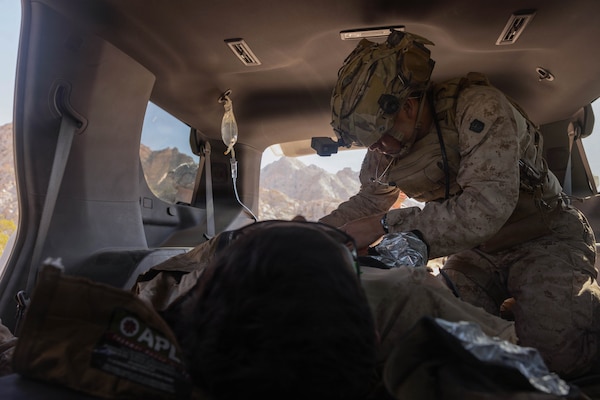 U.S. Navy Hospital Corpsman 3rd Class Haden Adsitt with 1st Combat Engineer Battalion, 1st Marine Division, assigned to Joint Task Force-Southern Border (JTF-SB), assesses a mock patient, Marine Corps Cpl. Landon Carden, an infantry rifleman, during a medical evacuation training exercise with AeroCare Medical Transport in Yuma, Ariz., Feb. 7, 2026. Joint training ensures that JTF-SB personnel are prepared to work with AeroCare Medical Transport teams if a medical emergency occurs in remote area along the southern border. U.S. Northern Command is working side-by-side with the Department of Homeland Security and the U.S. Customs and Border Protection within narrowly defined authorities to provide unique military capabilities to protect the territorial integrity of the U.S. southern border. (U.S. Marine Corps photo by Lance Cpl. Stella Tedesco)