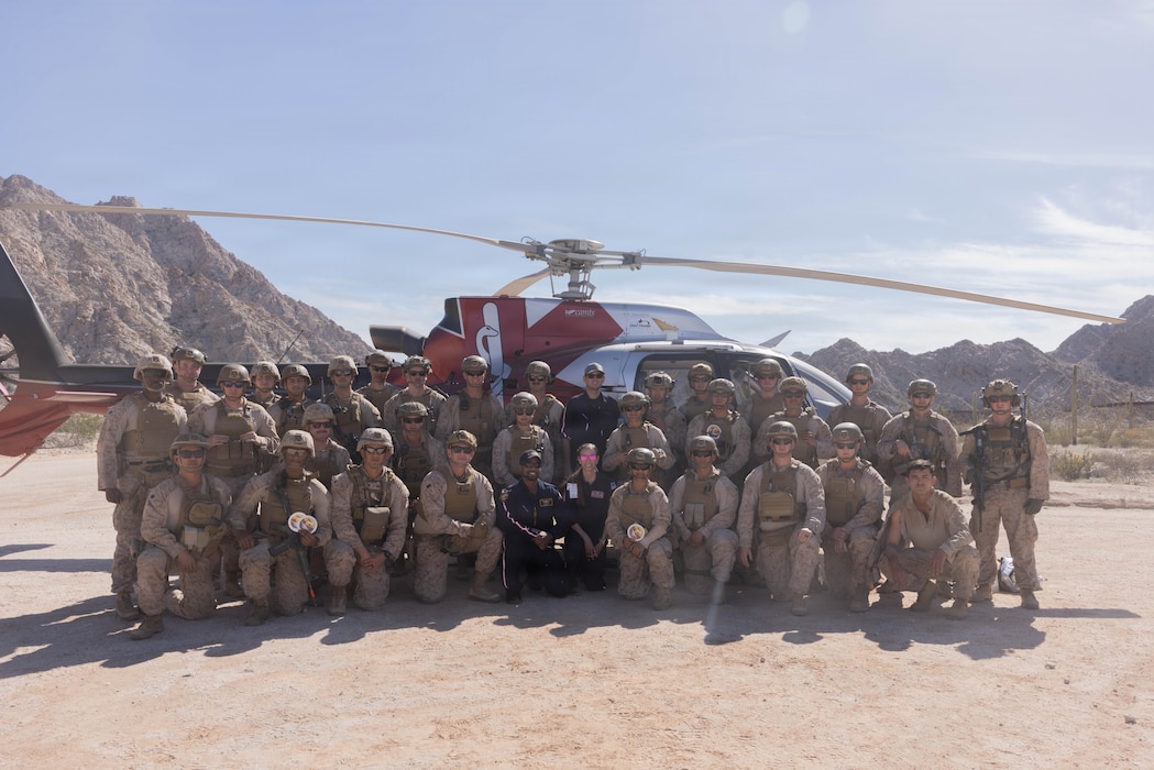 U.S. Marines and Sailors with 1st Combat Engineer Battalion, 1st Marine Division, assigned to Joint Task Force-Southern Border (JTF-SB), and AeroCare Headquarters pose for a group photo after a simulated medical evacuation in Yuma, Ariz., Feb. 7, 2026. Joint training ensures that JTF-SB personnel are prepared to work with AeroCare Medical Transport teams if a medical emergency occurs in remote area along the southern border. U.S. Northern Command is working side-by-side with the Department of Homeland Security and the U.S. Customs and Border Protection within narrowly defined authorities to provide unique military capabilities to protect the territorial integrity of the U.S. southern border. (U.S. Marine Corps photo by Lance Cpl. Stella Tedesco)