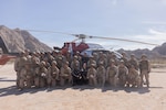 U.S. Marines and Sailors with 1st Combat Engineer Battalion, 1st Marine Division, assigned to Joint Task Force-Southern Border (JTF-SB), and AeroCare Headquarters pose for a group photo after a simulated medical evacuation in Yuma, Ariz., Feb. 7, 2026. Joint training ensures that JTF-SB personnel are prepared to work with AeroCare Medical Transport teams if a medical emergency occurs in remote area along the southern border. U.S. Northern Command is working side-by-side with the Department of Homeland Security and the U.S. Customs and Border Protection within narrowly defined authorities to provide unique military capabilities to protect the territorial integrity of the U.S. southern border. (U.S. Marine Corps photo by Lance Cpl. Stella Tedesco)