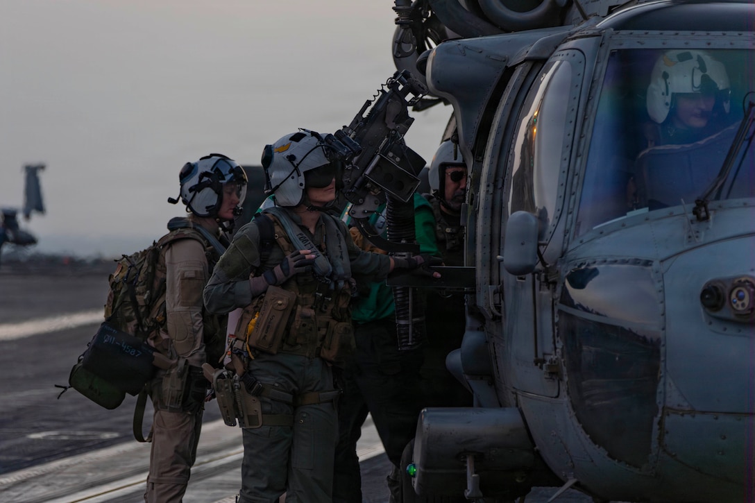 U.S. Sailors prepare an MH-60S Sea Hawk helicopter, attached to Helicopter Sea Combat Squadron (HSC) 14 for flight operations on the flight deck of Nimitz-class aircraft carrier USS Abraham Lincoln (CVN 72) in support of Operation Epic Fury, March. 4, 2026. (U.S. Navy photo)