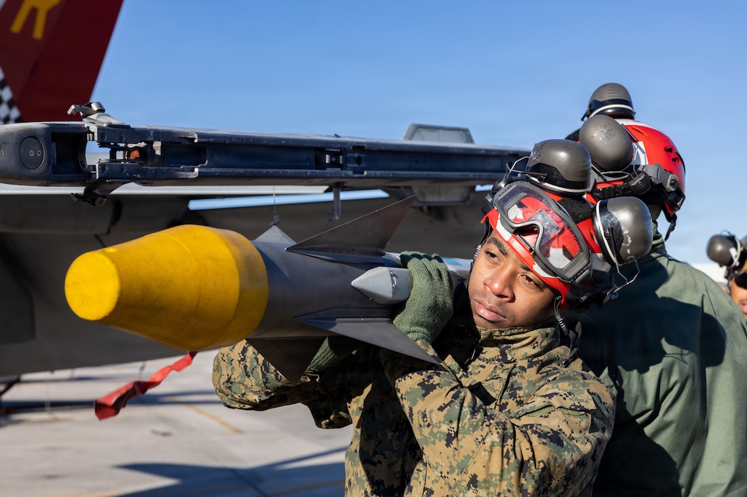 U.S. Marine Corps Cpl. Xavier Gregory, aviation ordnance systems technician, Marine Fighter Attack Squadron 312, Marine Aircraft Group 31, 2nd Marine Aircraft Wing, loads ordnance and conducts pre-flight operations at Marine Corps Air Station Beaufort, South Carolina, January 27, 2026. The main job duties of an aviation ordnance systems technician include accounting, stowage, breakout, testing, maintenance, assembly and transportation of airborne armament equipment and armament-handling equipment. (U.S. Marine Corps photo by Lance Cpl. Brianna Davidson)