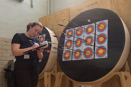 Elizabeth Spencer, a volunteer for the Army Recovery Program, records competitors' scores during an archery competition March 3, 2026.