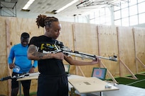 U.S. Army Staff Sgt. Jada Lassiter, assigned to Fort Belvoir, Virginia, conducts a functions check on her air rifle to ensure precision and accuracy March 2, 2026.