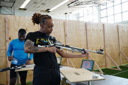 U.S. Army Staff Sgt. Jada Lassiter, assigned to Fort Belvoir, Virginia, conducts a functions check on her air rifle to ensure precision and accuracy March 2, 2026.