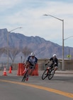 Cyclists round a corner during a one-mile bicycle time trial as part of Army Trials 2026, March 1, 2026, at Fort Bliss, Texas.