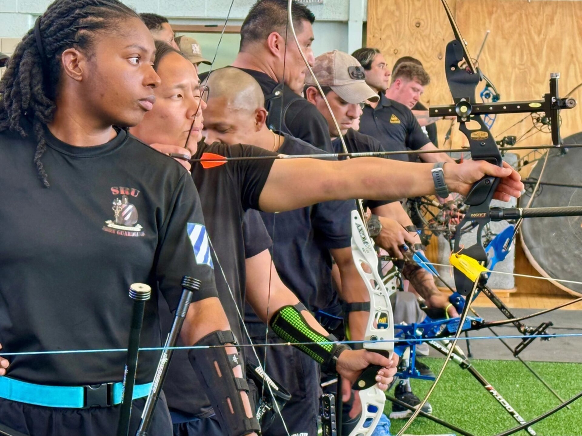 Retired U.S. Army Capt. Kyra Maggio, second from left, aims down range toward her target during the Archery competition at the 2026 Army Trials held at Fort Bliss, March 3, 2026.