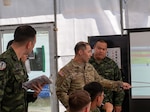 U.S. Army Lt. Col. Taihei Hongo, chief of staff, 10th Homeland Response Force and deputy Command and Control, conducts the Combined Forces Land Component Commanders Update Brief with Thai and Singaporean service members during Exercise Cobra Gold 2026 at Camp Red Horse, Rayong province, Thailand, March 2, 2026. Cobra Gold is the Indo-Pacific’s largest annual military exercise in mainland Asia, co-hosted by the U.S. and Thailand. The exercise brings together participants from multiple nations for military training and humanitarian projects, strengthening regional partnerships and demonstrating U.S. commitment to Indo-Pacific security. Photo by Spc. Marco Mayorquin.