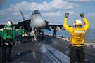 A U.S. Sailor signals an F/A-18E Super Hornet, attached to Strike Fighter Squadron (VFA) 14, on the flight deck of Nimitz-class aircraft carrier USS Abraham Lincoln (CVN 72) in support of Operation Epic Fury, March 4, 2026. (U.S. Navy photo)