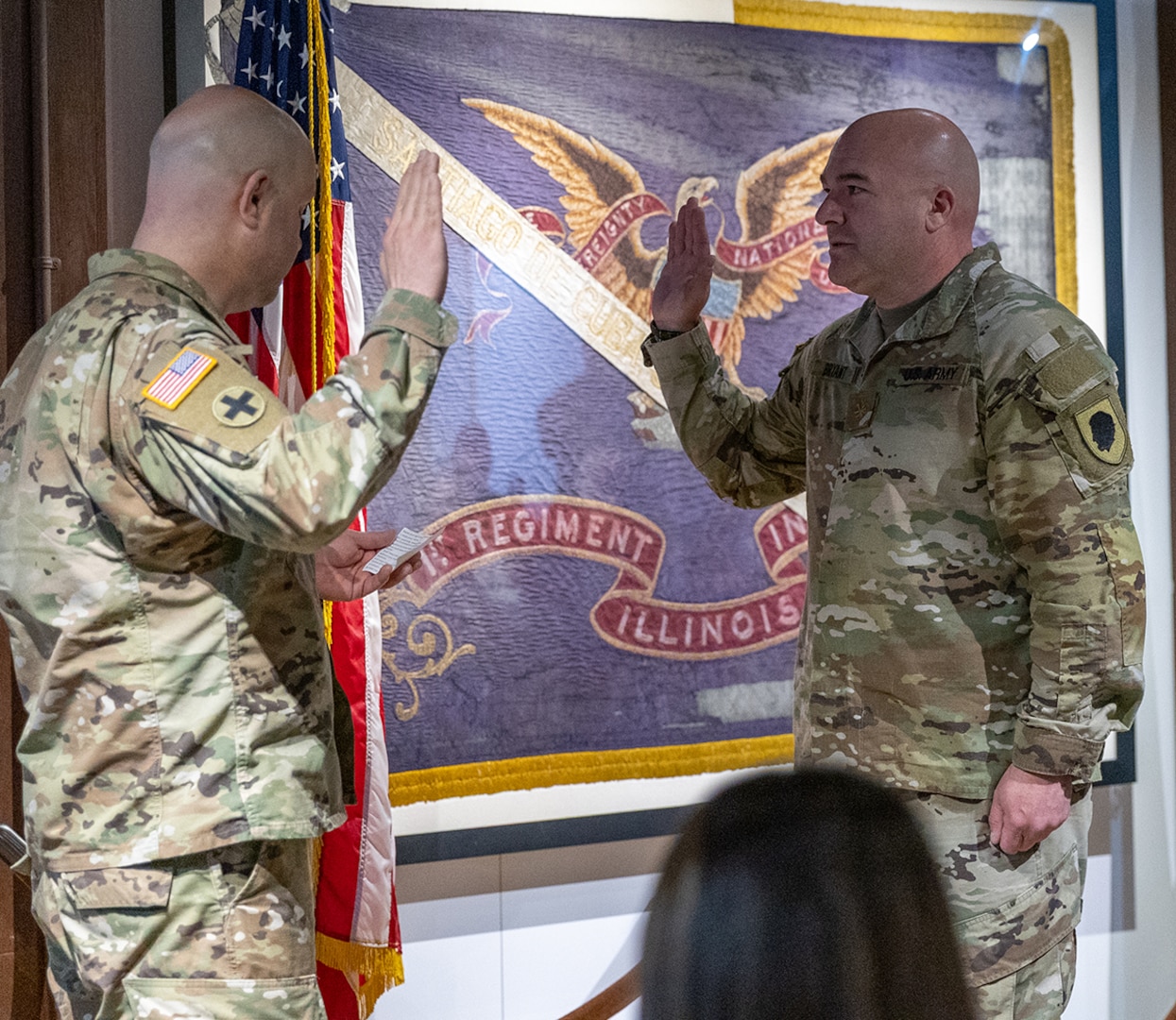 Col. Matthew Garrison, Chief of the Illinois National Guard Joint Staff, administers the oath of office to newly promoted Maj. Aaron Bryant during a promotion ceremony March 5 at the Illinois State Military Museum in Springfield.