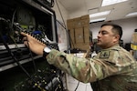 U.S. Army Staff Sgt. Daniel Pau, an information technology specialist assigned to the 1st Battalion, 297th Infantry Regiment, Alaska Army National Guard, operates a high-frequency radio while participating in exercise Arctic Connect at the Alaska National Guard’s Joint Operations Center on Joint Base Elmendorf-Richardson, Alaska, March 3, 2026. Arctic Connect is high-frequency radio communications exercise conducted across Alaska, designed to validate select Alaska Organized Militia units’ ability to communicate with the Alaska National Guard’s Joint Operations Center and with each other. Photo by Alejandro Peña.