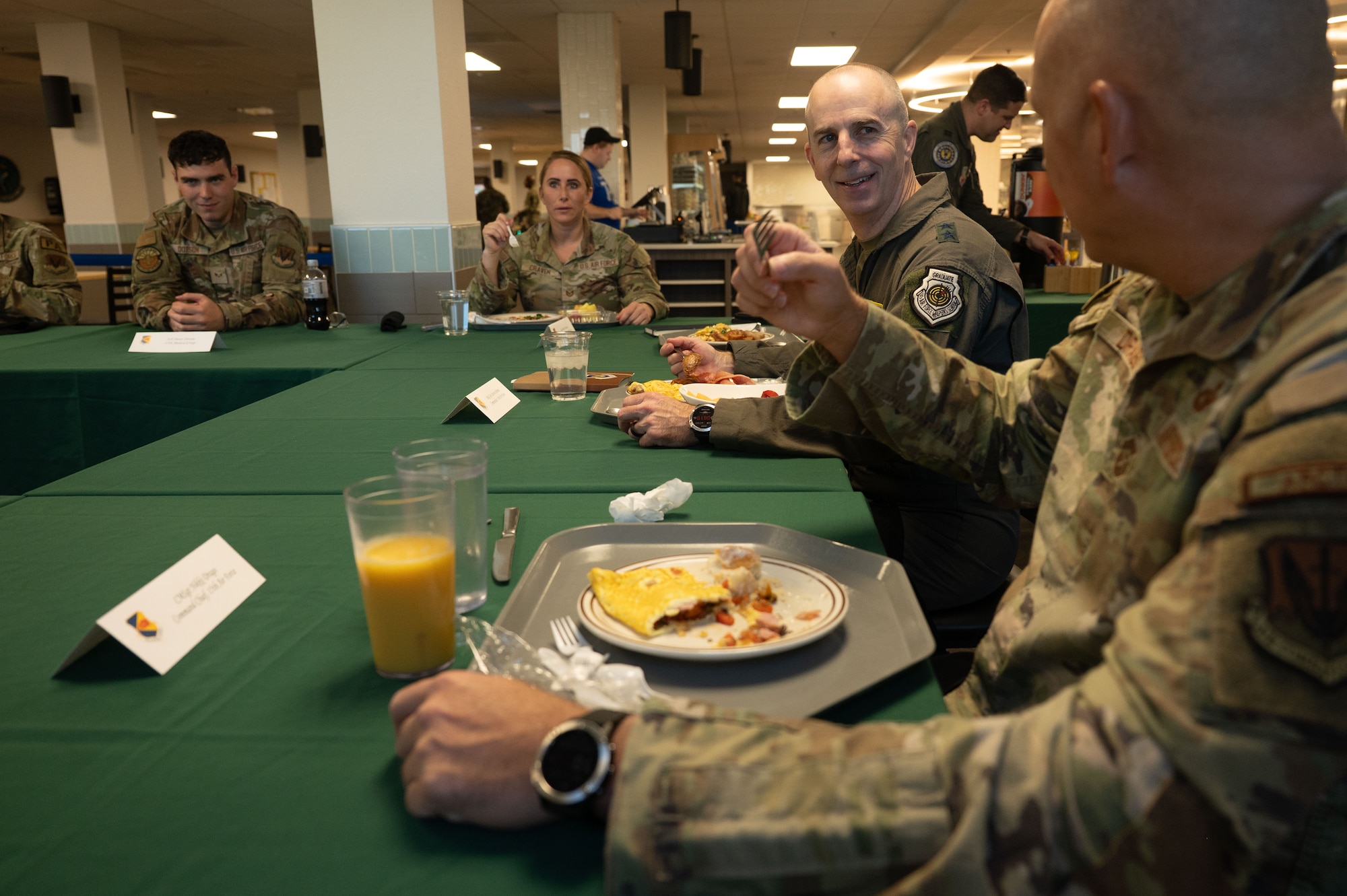 U.S. Air Force Maj. Gen. Steven Behmer, 15th Air Force commander, and Chief Master Sgt. Nikki Drago, 15th Air Force command chief, eat breakfast with Airmen at Davis-Monthan Air Force Base, Arizona, Feb. 27, 2026. The leaders visited the installation to engage with Airmen and discuss mission readiness, lethality and ongoing operations. (U.S. Air Force photo by Airman 1st Class Jaden Kidd)