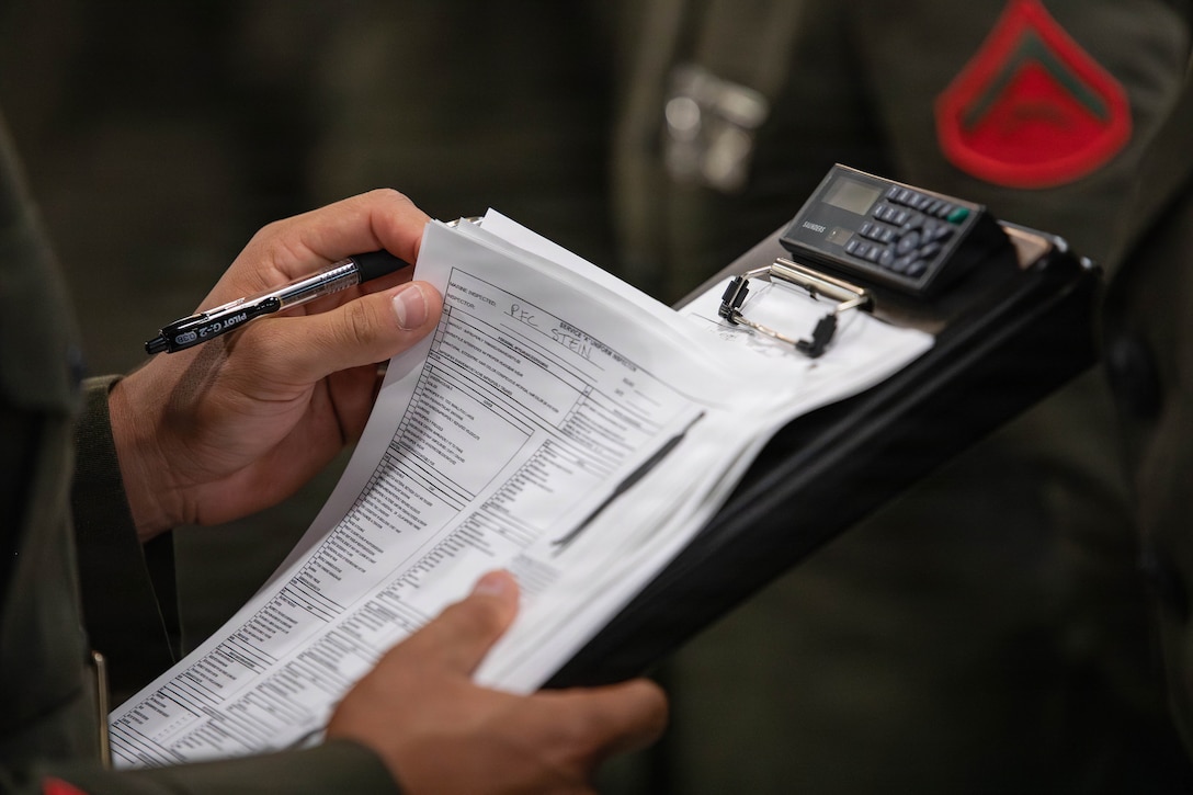 U.S. Marine Corps Sgt. John Zostant, a military police officer with Headquarters Battalion, Marine Forces Reserve, checks a uniform inspection paper during a service alpha uniform inspection, Marine Corps Support Facility New Orleans, Feb. 27, 2026. The inspection was conducted to evaluate the Marines’ appearance and adherence to standards while promoting discipline and attention to detail. (U.S. Marine Corps photo by Lance Cpl. Van Hoang)