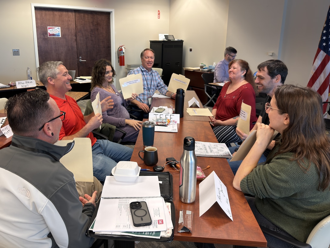 People sitting around a table having a discussion in a conference room.