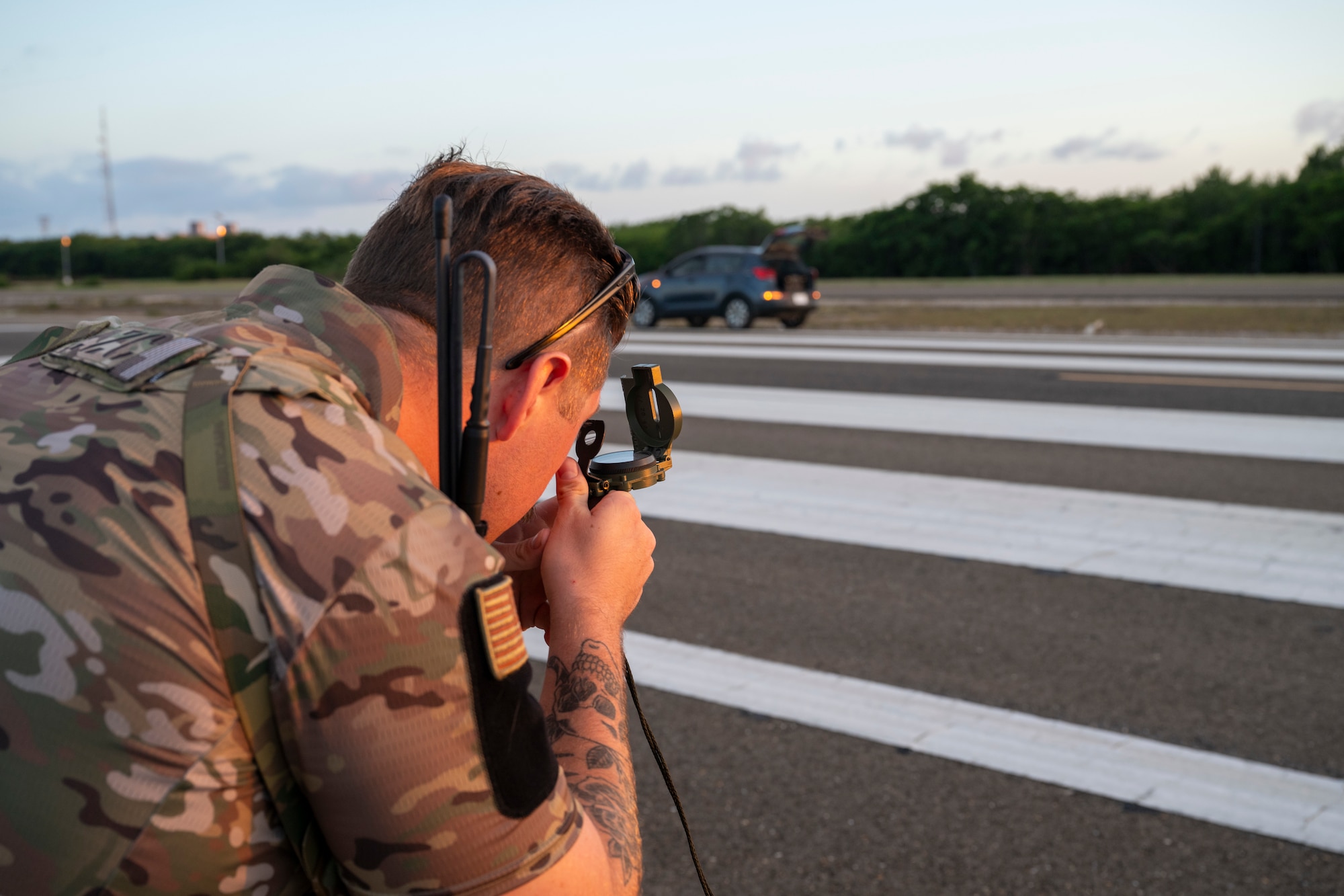 Man uses tool on airfield.