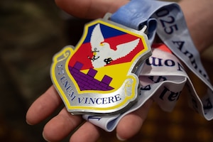 U.S. Air Force Senior Airman Aidan Thompson, 87th Air Base Wing public affairs journeyman, displays his annual award nomination medallion at Joint Base McGuire-Dix-Lakehurst, N.J., Feb. 26, 2026.