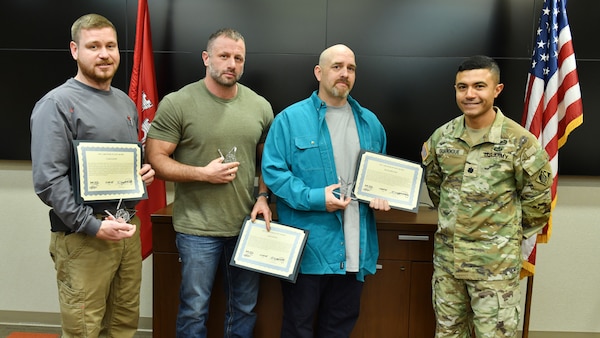 Lt. Col. Guillermo Guandique, U.S. Army Corps of Engineers Nashville District commander (Right), presents 2025 Star of Life Awards March 5, 2026, from the USACE Great Lakes and Ohio River Division commander to Case Eaton (Left), Alex Hays (Second from Left), and Kevin Reuter during a ceremony at the district headquarters in Nashville, Tennessee. The awards recognize this team’s combined efforts to rescue a distressed kayaker above Barkley Dam June 17, 2025, on the Cumberland River in Kuttawa, Kentucky. Chris Meeks was also recognized but not present at the ceremony. (USACE Photo by Summer Thatcher)