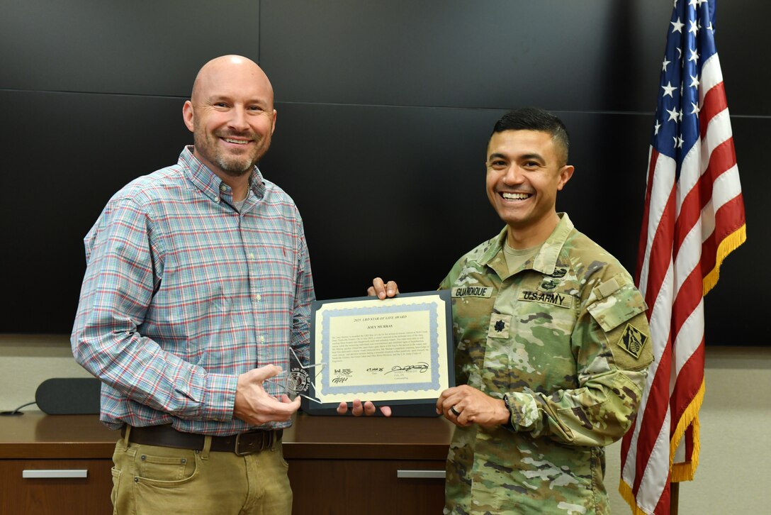 Lt. Col. Guillermo Guandique (Right), U.S. Army Corps of Engineers Nashville District commander (Right), presents the 2025 Star of Life Award March 5, 2026, from the USACE Great Lakes and Ohio River Division commander to Joey Murray during a ceremony at the district headquarters in Nashville, Tennessee. The award recognizes his effort to rescue a person thrown overboard into cold and turbulent water below Wolf Creek Dam July 25, 2025, on the Cumberland River in Jamestown, Kentucky. (USACE Photo by Summer Thatcher)