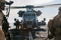 U.S. Marines with Lima Company, Battalion Landing Team 3/5, 11th Marine Expeditionary Unit, board a CH-53E Super Stallion with Marine Medium Tiltrotor Squadron (VMM) 163 (Reinforced), 11th MEU, on the flight deck of San Antonio-class amphibious transport dock ship USS Portland (LPD 27) during an amphibious assault in the Pacific Ocean, March 2, 2026.