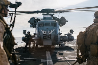 U.S. Marines with Lima Company, Battalion Landing Team 3/5, 11th Marine Expeditionary Unit, board a CH-53E Super Stallion with Marine Medium Tiltrotor Squadron (VMM) 163 (Reinforced), 11th MEU, on the flight deck of San Antonio-class amphibious transport dock ship USS Portland (LPD 27) during an amphibious assault in the Pacific Ocean, March 2, 2026.