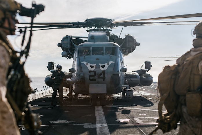 U.S. Marines with Lima Company, Battalion Landing Team 3/5, 11th Marine Expeditionary Unit, board a CH-53E Super Stallion with Marine Medium Tiltrotor Squadron (VMM) 163 (Reinforced), 11th MEU, on the flight deck of San Antonio-class amphibious transport dock ship USS Portland (LPD 27) during an amphibious assault in the Pacific Ocean, March 2, 2026.