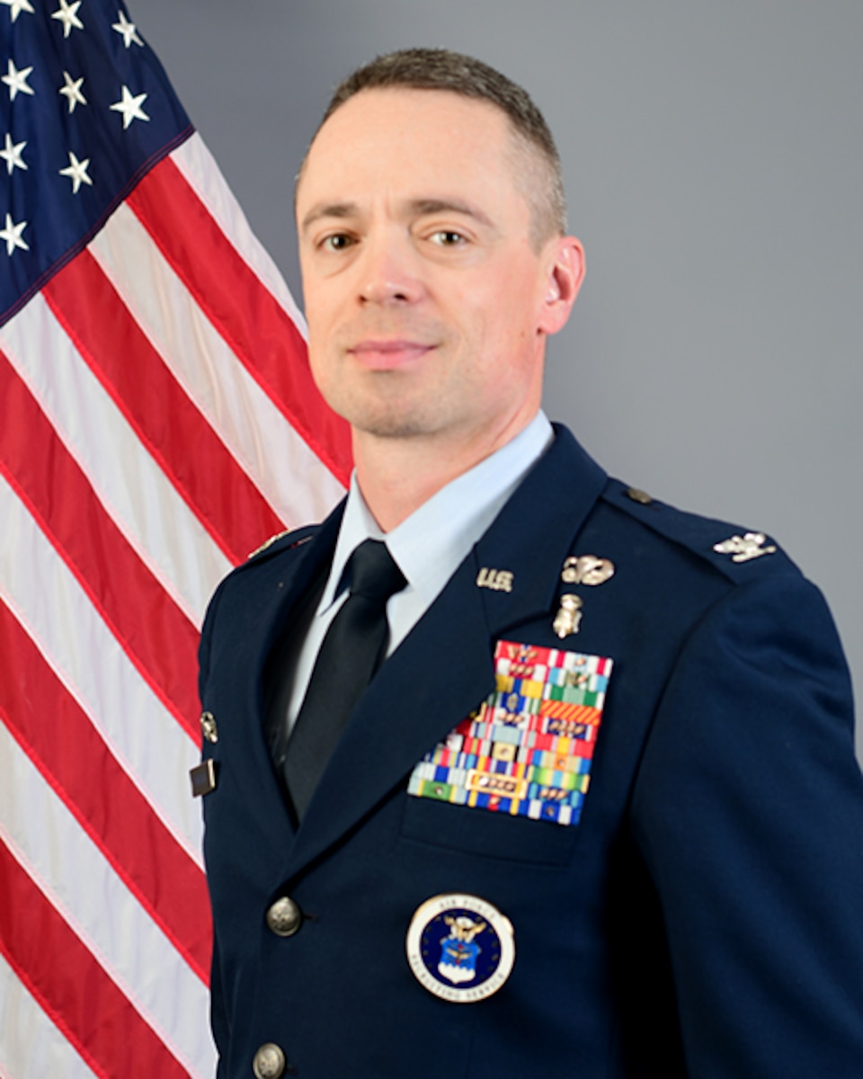 Person poses for picture in front of US flag