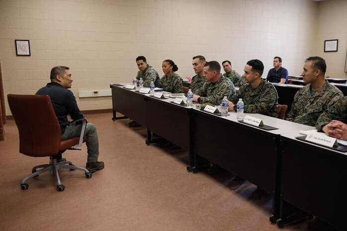 The Honorable Hung Cao, Under Secretary of the Navy, left, speaks with a panel of instructors with The Basic School, Training Command, at Marine Corps Base Quantico, Virginia, Feb. 27, 2026. During a visit to TBS and Officer Candidates School, Cao met with senior leaders and Marines to observe training and gain a deeper understanding of the methods the Marine Corps uses to train, screen, and evaluate its candidates and newly commissioned officers