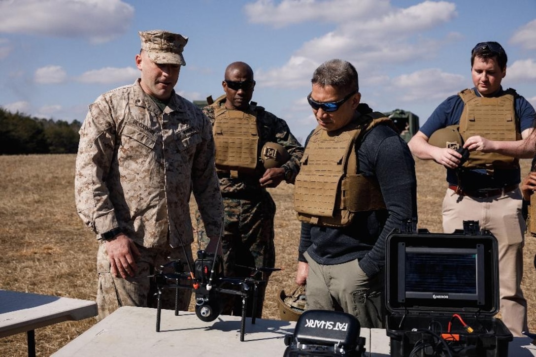 The Honorable Hung Cao, Under Secretary of the Navy, right, receives a brief on small Unmanned Aircraft System implementation from Maj. Bradley Bloxdorf, air officer with The Basic School, Training Command at Marine Corps Base Quantico, Virginia, Feb. 27, 2026. During a visit to TBS and Officer Candidates School, Cao met with senior leaders and Marines to observe training and gain a deeper understanding of the methods the Marine Corps uses to train, screen, and evaluate its candidates and newly commissioned officers.