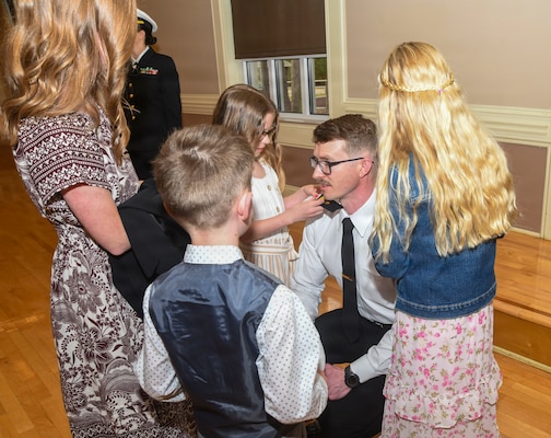 260306-N-FB730-1044 CAMP LEJEUNE. (March 6, 2026) Lt. j.g.  Andrew Davidson has his officer shoulder boards placed by his family during the Interservice Physicians Assistants Program (IPAP) graduation at Marston Pavilion on March 6, 2026.  Naval Medical Center Camp Lejeune serves as a Phase II site for Navy Medicine’s Interservice Physician Assistant Program. The program has graduated and commissioned more than 35 Navy officers since the program’s establishment in 2021. (U.S. Navy photo by Mass Communications Specialist second class Justin Woods)