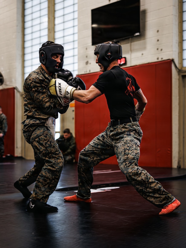 U.S. Marines with Martial Arts Instructor course 42-26 spar during the culminating event at The Basic School on Marine Corps Base Quantico, Virginia, Feb. 13, 2026. The MAI culminating event combines techniques used within the Marine Corps Martial Arts program in one final test to ensure the Marines are ready to conduct belt advancement within individual units to uphold the tradition of warrior ethos in the corps. (U.S. Marine Corps photo by Cpl. Braydon Rogers)