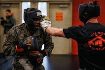 U.S. Marines with Martial Arts Instructor course 42-26 spar during the culminating event at The Basic School on Marine Corps Base Quantico, Virginia, Feb. 13, 2026. The MAI culminating event combines techniques used within the Marine Corps Martial Arts program in one final test to ensure the Marines are ready to conduct belt advancement within individual units to uphold the tradition of warrior ethos in the corps. (U.S. Marine Corps photo by Cpl. Braydon Rogers)