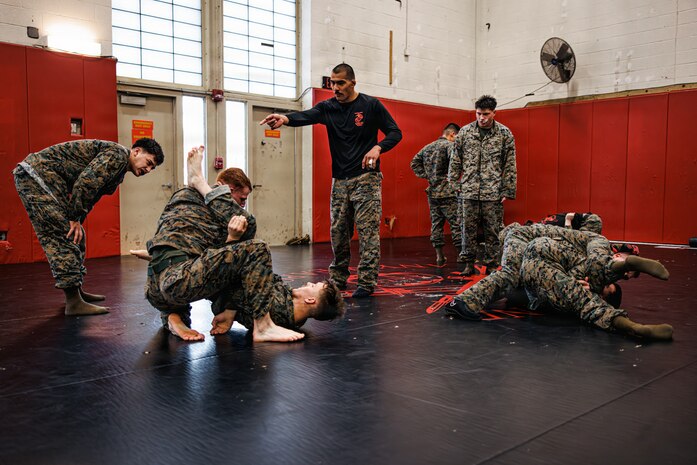 U.S. Marines with Martial Arts Instructor course 42-26 spar during the culminating event at The Basic School on Marine Corps Base Quantico, Virginia, Feb. 13, 2026. The MAI culminating event combines techniques used within the Marine Corps Martial Arts program in one final test to ensure the Marines are ready to conduct belt advancement within individual units to uphold the tradition of warrior ethos in the corps. (U.S. Marine Corps photo by Cpl. Braydon Rogers)
