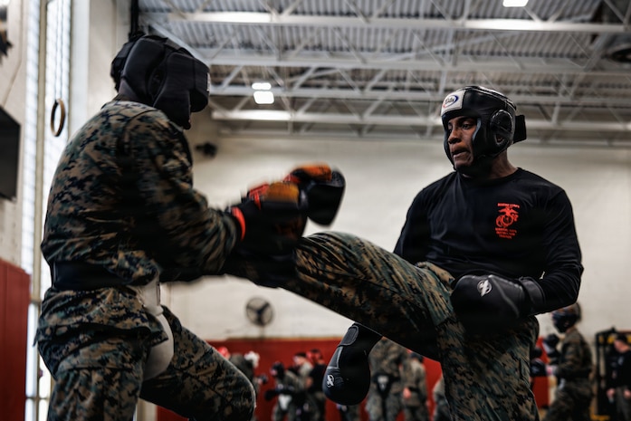 U.S. Marines with Martial Arts Instructor course 42-26 spar during the culminating event at The Basic School on Marine Corps Base Quantico, Virginia, Feb. 13, 2026. The MAI culminating event combines techniques used within the Marine Corps Martial Arts program in one final test to ensure the Marines are ready to conduct belt advancement within individual units to uphold the tradition of warrior ethos in the corps. (U.S. Marine Corps photo by Cpl. Braydon Rogers)