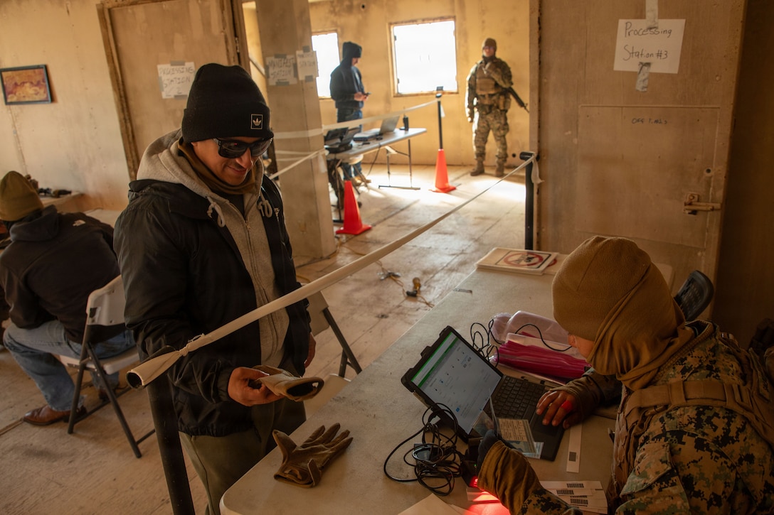 A U.S. Marine with the 24th Marine Expeditionary Unit, processes evacuees during a simulated non-combatant evacuation operation exercise as part of the 24th MEU’s certification exercise on Marine Corps Outlying Landing Field Atlantic, North Carolina, Feb. 24, 2026. CERTEX is a land-based pre-deployment exercise that enhances the integration and collective capability of the Marine Air-Ground Task Force while providing the 24th MEU with an opportunity to train and execute operations in austere and urban environments. (U.S. Marine Corps photo by Lance Cpl. Payton Walley)