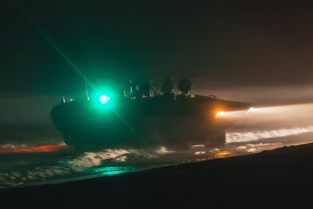A U.S. Marine Corps Amphibious Combat Vehicle with Alpha Company, 2nd Assault Amphibian Battalion, 2nd Marine Division, lands at Onslow Beach during a ship-to-shore movement from the San Antonio-class amphibious transport dock ship USS Arlington (LPD 24) as part of Type Commander’s Amphibious Training 26.1 at Marine Corps Base Camp Lejeune, N.C., March 4, 2026. TCAT is a military exercise designed to enhance mobility and integration between the U.S. Marine Corps and the U.S. Navy. It allows Marines and Sailors to gain hands-on experience of working side by side in amphibious planning and operations, including the use of multiple surface connectors and platforms. The training focuses on improving the necessary skills for real-world operations and effective collaboration between the Marine Corps and Naval teams. (U.S. Marine Corps photo by Sgt. Jorge Borjas)