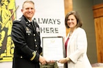 Lt. Col. Justin Wilkerson presents a certificate of appreciation to his wife, Mary Wilkerson, during his retirement ceremony.