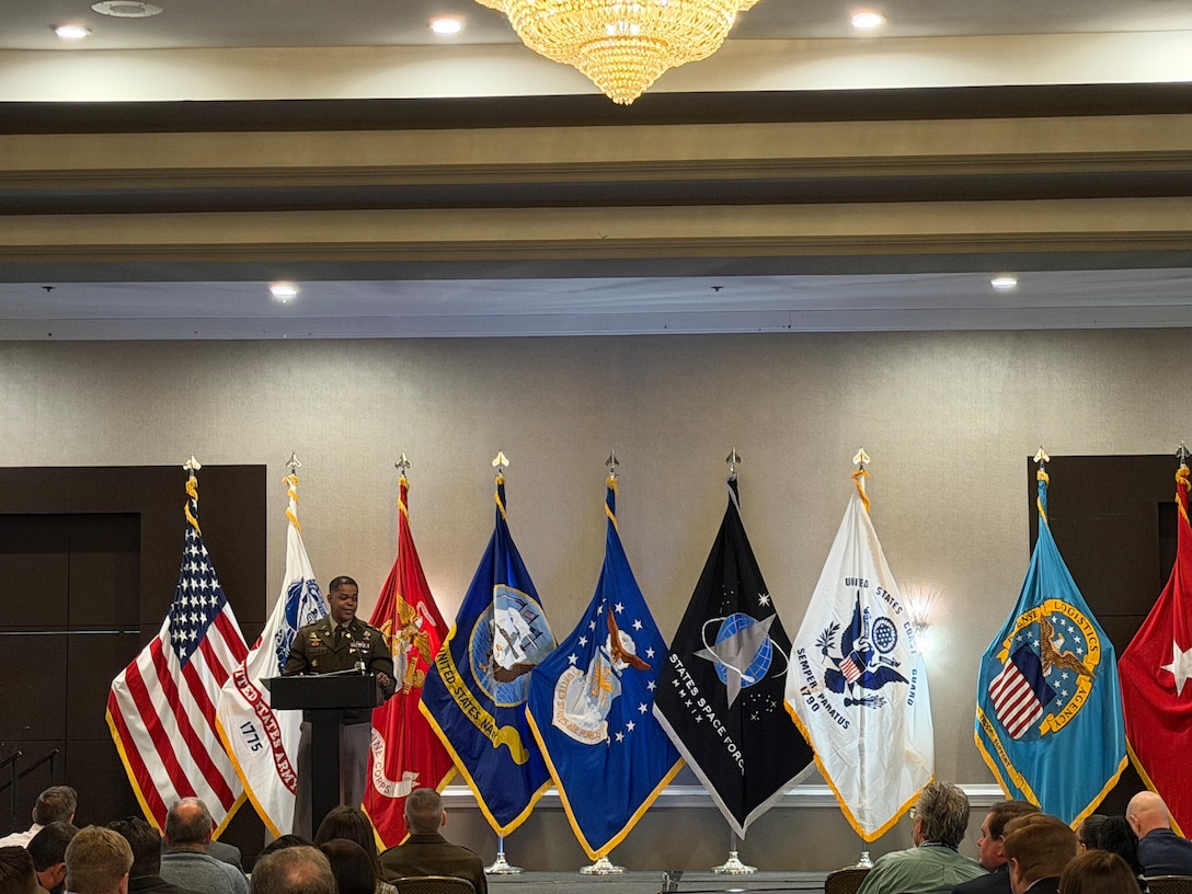 man in uniform stands at podium