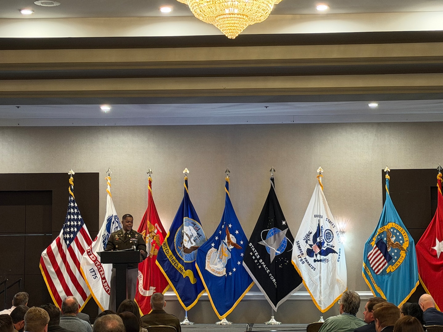 man in uniform stands at podium