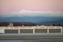 A Vermont Air National Guard hangar, assigned to the 158th Fighter Wing, sits below Mount Mansfield after sunset in South Burlington, Vermont, Nov. 19, 2025. The 158th Fighter Wing conducted flying operations that evening. (U.S. Air National Guard photo by Airman 1st Class Raymond LaChance)