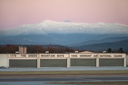 A Vermont Air National Guard hangar, assigned to the 158th Fighter Wing, sits below Mount Mansfield after sunset in South Burlington, Vermont, Nov. 19, 2025. The 158th Fighter Wing conducted flying operations that evening. (U.S. Air National Guard photo by Airman 1st Class Raymond LaChance)