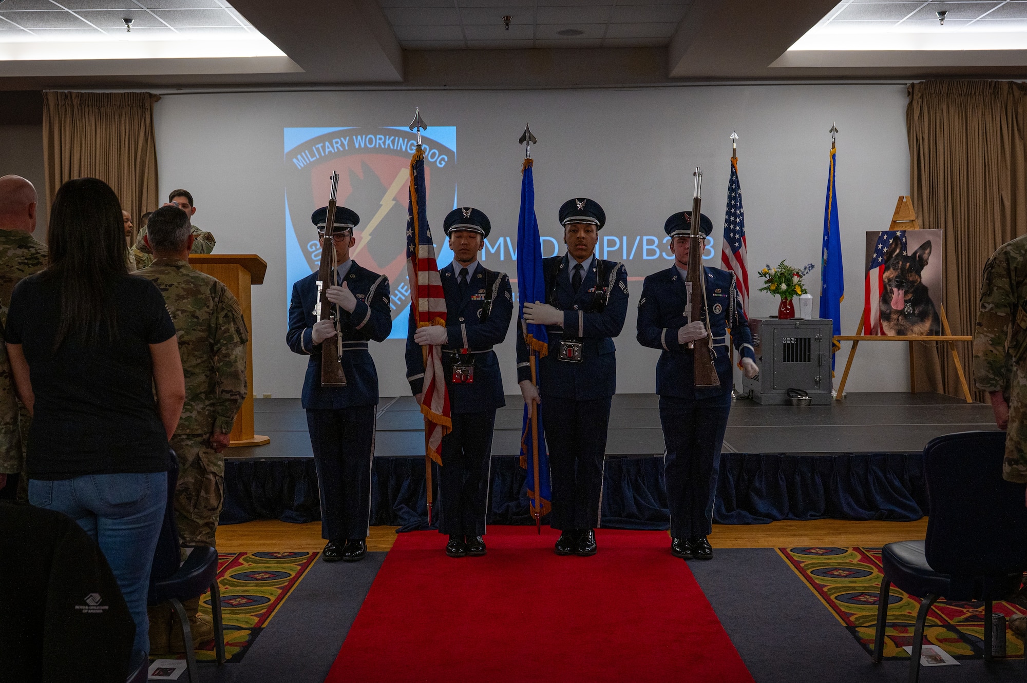 A photo of a group of people standing in front a stage.