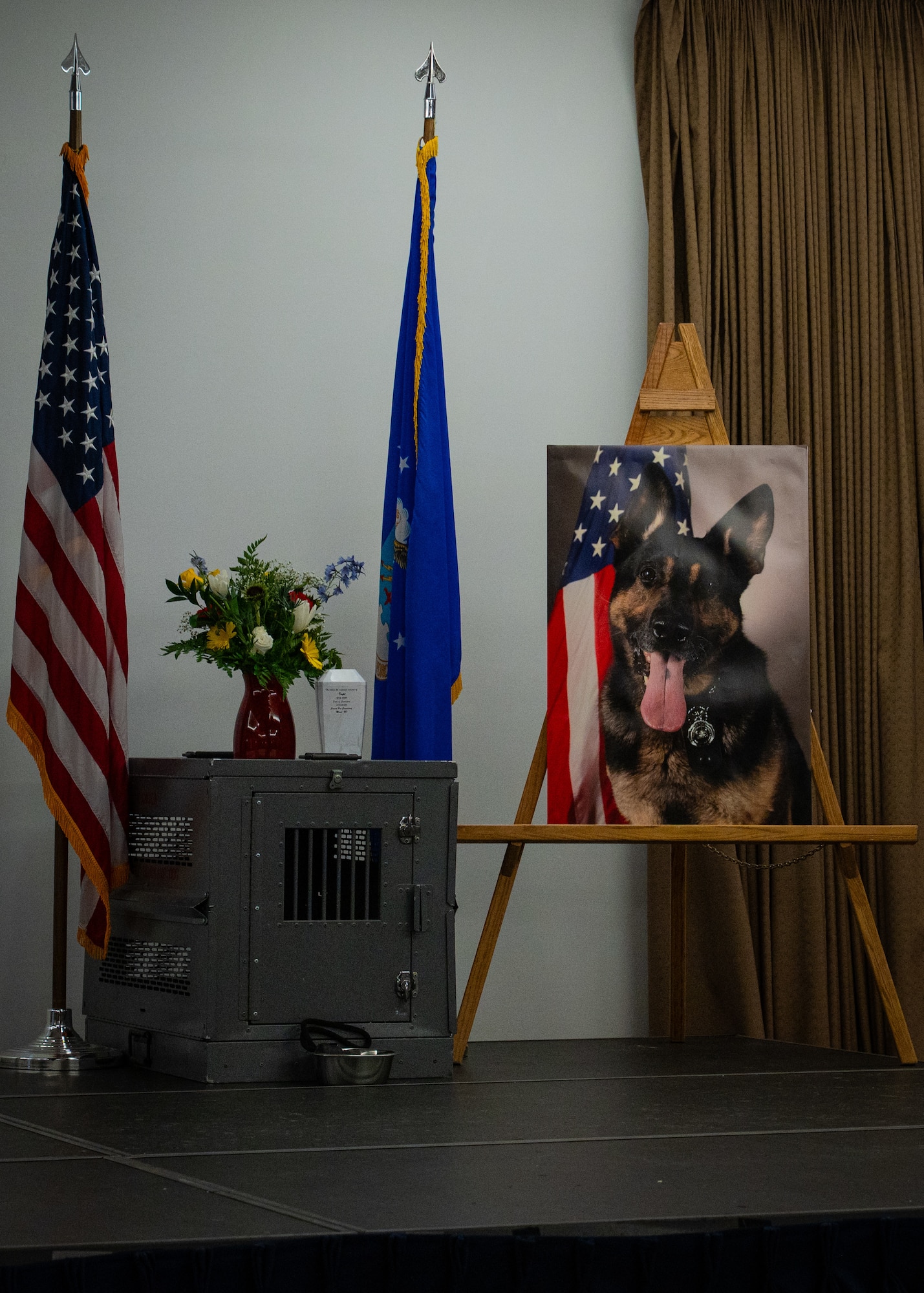 A photo of a memorial stands on a stage.
