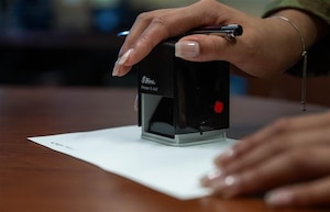U.S. Air Force Senior Airman Amiah Tindal, then a 15th Wing Judge Advocate civil law paralegal, notarizes a document during Legal Assistance Readiness Week at Joint Base Pearl Harbor-Hickam, Hawaii, May 1, 2025. The Arnold Engineering Development Complex Safety team is providing guidance to help members of Team AEDC prepare in the event of the unexpected. (U.S. Air Force photo by Senior Airman Caroline Strickland)