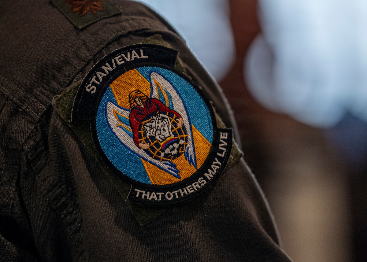 A U.S. Air Force Airman assigned to the 71st Rescue Squadron listens to retired Col. Steve Colby during Saluting Our Aviation Roots (SOAR) Week at Moody Air Force Base, Georgia, Feb. 27, 2026. Colby reflected on his experiences in rescue operations, emphasizing leadership and resilience throughout his career. (U.S. Air Force photo by Senior Airman Leonid Soubbotine)