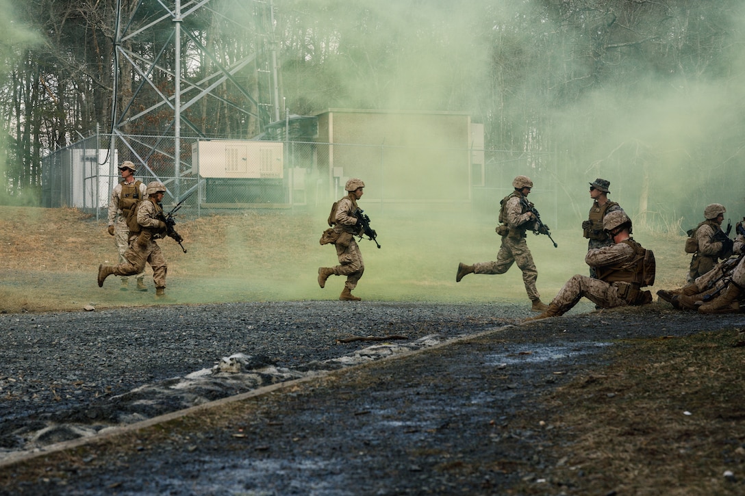 U.S. Marine Corps students with Company F, The Basic School, run towards a building during a platoon attack at Marine Corps Base Quantico, Virginia, Feb. 25, 2026. The purpose of the simulated platoon attacks was to introduce Marines to the fundamentals of Military Operations on Urban Terrain training, evaluate their leadership in high-stress environments, and develop them into confident, provisional rifle platoon commanders. (U.S. Marine Corps photo by Cpl. Joshua Barker)