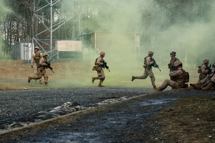U.S. Marine Corps students with Company F, The Basic School, run towards a building during a platoon attack at Marine Corps Base Quantico, Virginia, Feb. 25, 2026. The purpose of the simulated platoon attacks was to introduce Marines to the fundamentals of Military Operations on Urban Terrain training, evaluate their leadership in high-stress environments, and develop them into confident, provisional rifle platoon commanders. (U.S. Marine Corps photo by Cpl. Joshua Barker)