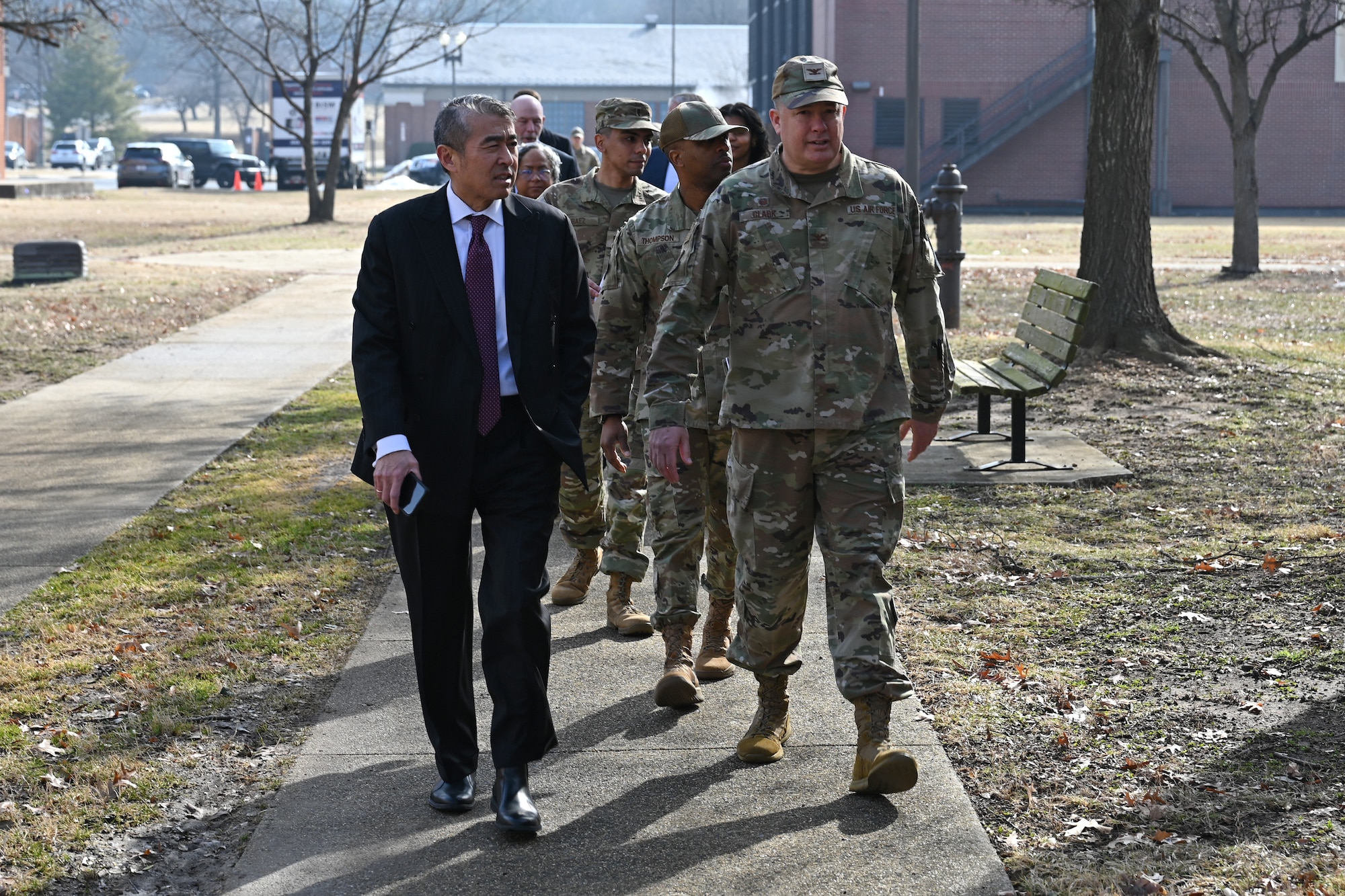 photo of U.S. Air Force service members and civilians walking down a sidewalk