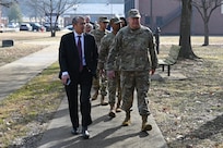 photo of U.S. Air Force service members and civilians walking down a sidewalk