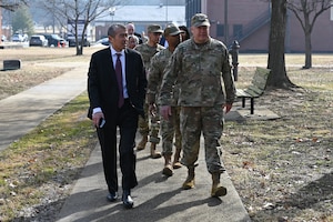 photo of U.S. Air Force service members and civilians walking down a sidewalk
