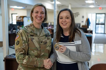 Col. Michelle M. Williams, U.S. Army Financial Management Command commander, presents a commander’s challenge coin to Cynthia Bujarski, USAFMCOM Fort Knox Army Military Pay Office military pay technician, at Fort Knox, Ky., March 4, 2026. USAFMCOM’s leadership visited the Fort Knox AMPO during a major subordinate command update to the U.S. Army Materiel Command and thanked the employees for their hard work in supporting Soldiers and their families. (U.S. Army photo by Mark R. W. Orders-Woempner)