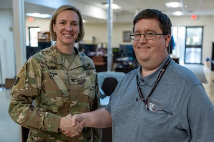 Col. Michelle M. Williams, U.S. Army Financial Management Command commander, presents a commander’s challenge coin to Timothy Thompson, USAFMCOM Fort Knox Army Military Pay Office computer assistant, at Fort Knox, Ky., March 4, 2026. USAFMCOM’s leadership visited the Fort Knox AMPO during a major subordinate command update to the U.S. Army Materiel Command and thanked the employees for their hard work in supporting Soldiers and their families. (U.S. Army photo by Mark R. W. Orders-Woempner)